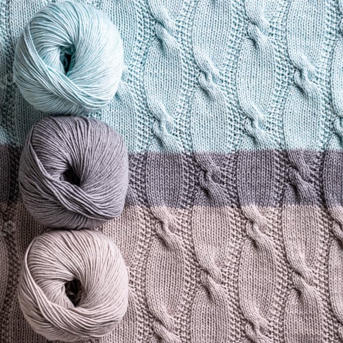 Preview: Colorful yarn spools on knitted background