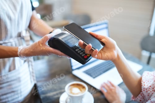 Preview: Paying by smartphone in coffee shop after coronavirus lockdown, hygiene concept