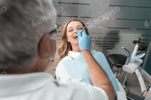 Preview: The patient feels professional care and trust in the dentist during the visit to the clinic. A woman