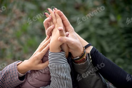 Preview: Group of people with their hands together as a symbol of teamwork,friendship