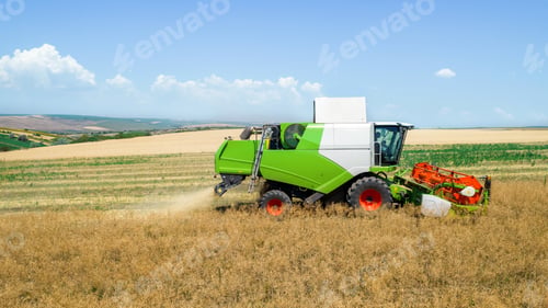 Preview: Aerial drone view of the harvester gathering crops
