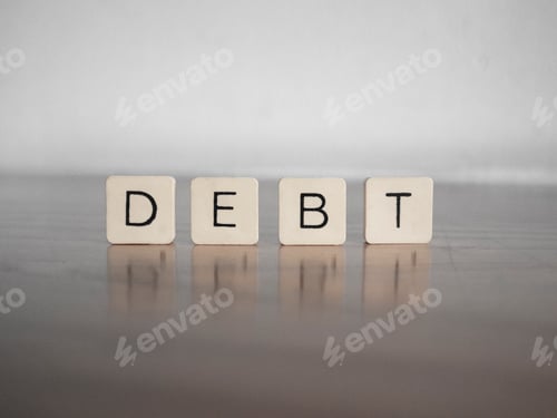 Preview: Close up of the word DEBT composed with scrabble letters
