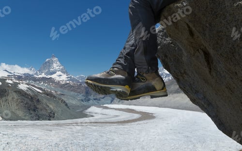 Preview: Man sitting on rock by the Matterhorn, Zermatt, Canton Wallis, Switzerland