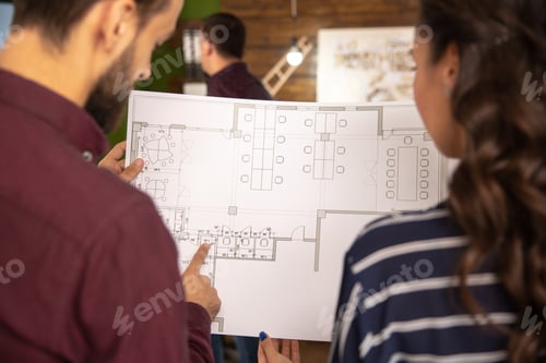 Preview: Close-up from the back with two architects holding a blue print