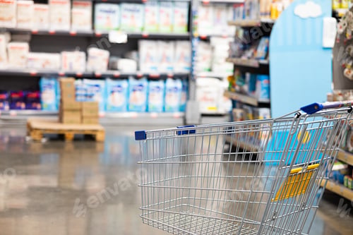 Preview: Abstract blurry photo of a supermarket with an empty shopping cart concept.