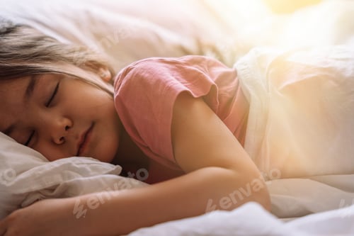 Preview: A little girl in pink pajamas sleeps in a white bed under the glare of the sun