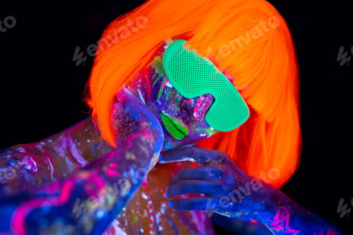 Preview: Fashion model woman in neon light, portrait of beautiful model girl with fluorescent make-up.