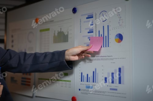 Preview: Person using sticky notes to analyze data charts on a board