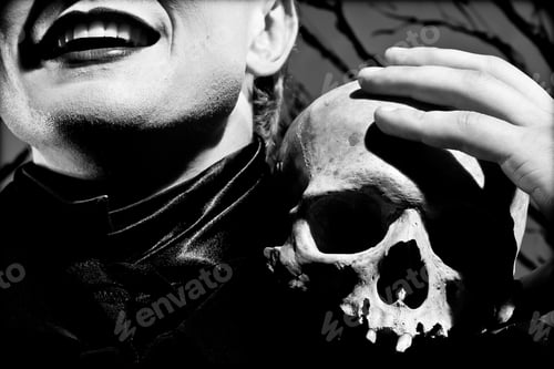 Preview: A young man dressed in black with a skull in his hands. Black and white. Artistic background created
