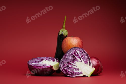 Preview: fresh ripe apple, eggplant, onion and sliced cabbage on red background
