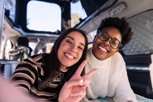 Preview: selfie photo of two women having fun in camper van