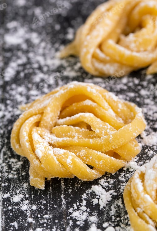 Preview: pasta with pasta ingredients on the dark wooden table top view