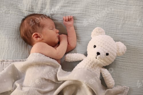 Preview: Bedtime. Cute little baby with toy bear sleeping in bed indoors, top view