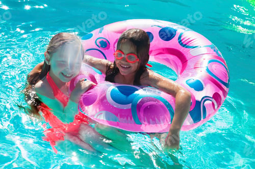 Preview: Girls with inflatable ring in swimming pool