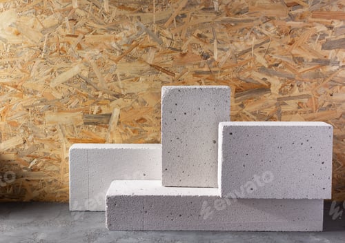 Preview: Aerated concrete block cube or bricks near osb wall background texture. Construction concept