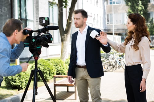 Preview: cameraman and professional news reporter with businessman refusing interview