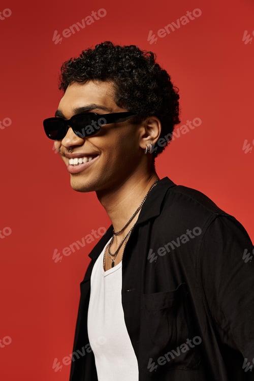 Preview: Cool Vibes: Young Man Smiles in Sunglasses on Red