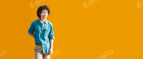 Preview: Man in denim shirt, yellow backdrop