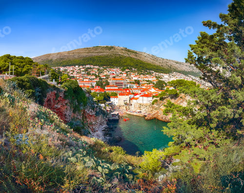 Preview: famous travel destination city of Dubrovnik - Suluci beach and old city on a sunny day.