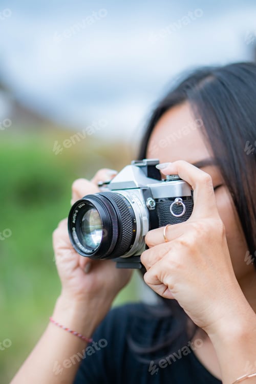 Preview: Woman photographing with vintage camera