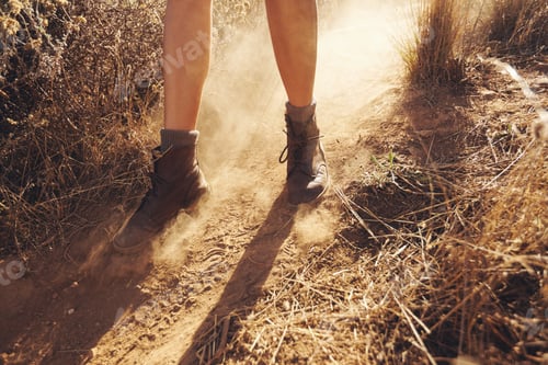 Preview: Young woman hiking on a mountain trail