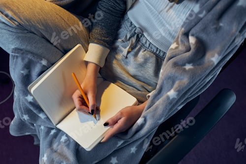 Preview: Student learning at home. Studying from home. Girl making notes. Writing journal. Cozy home