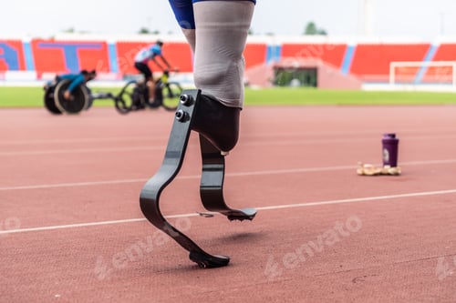 Preview: Close up of athlete disabled with prosthetic blades running at stadium.