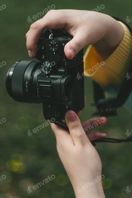 Preview: female hands holding a camera while filming