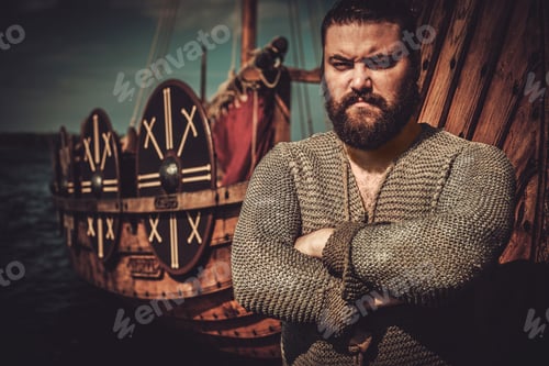 Preview: Viking with axe standing near drakkar on the seashore.