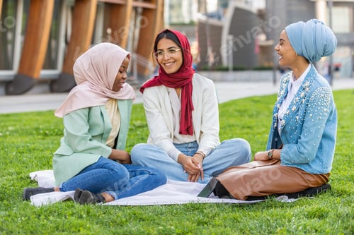 Preview: Beautiful muslim girl wearing hijab bonding outdoors