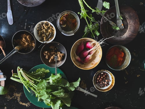 Preview: Top view of organic radishes, radishes, miso sauce, peppers, and