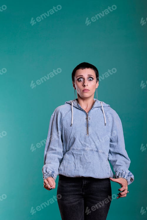 Preview: Portrait of frightened woman with short hair having nervous reaction during fashion shot