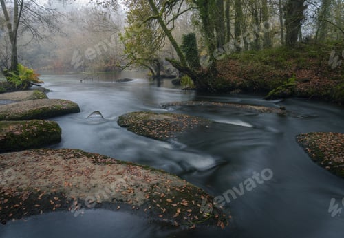 Preview: Rounded and worn rocks in the Mino river in autumn