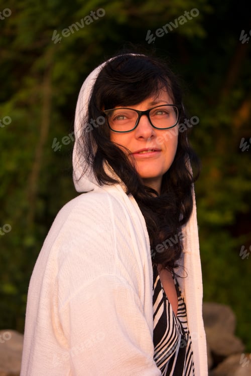Preview: Portrait of a woman with glasses and a white hoodie sweatshirt, waiting sunrise