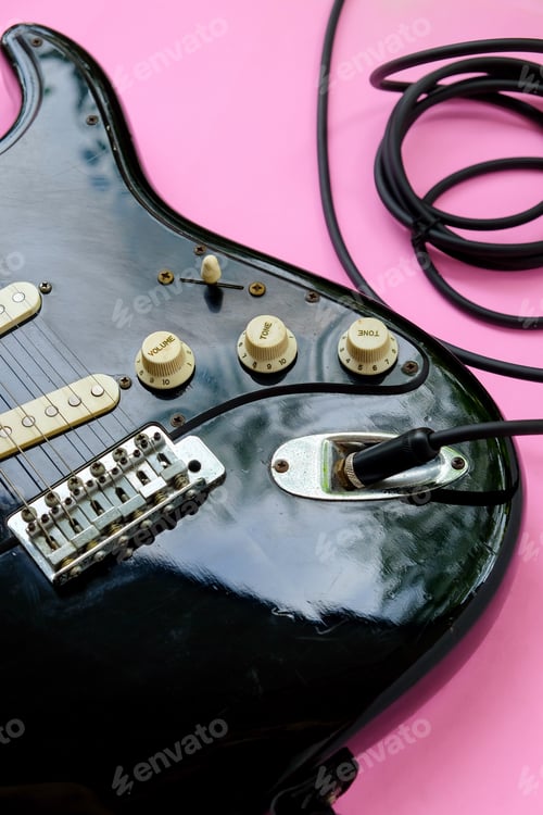 Preview: Electric guitar with cable on pink background