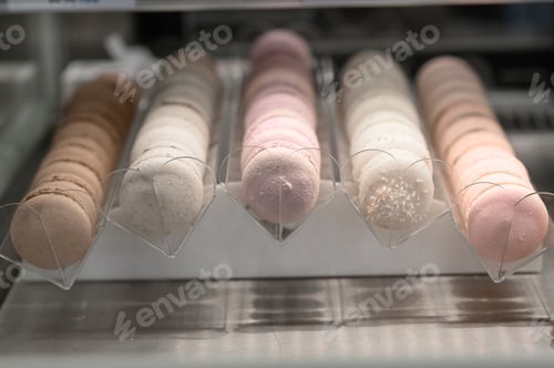 Preview: Fresh colored macaroons close-up, sale in coffee shop showcase.