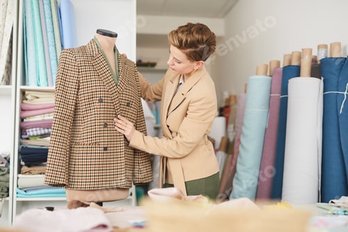 Preview: Tailor working with jacket in workshop