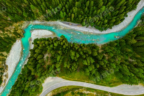 Preview: Inn River flowing in the forest in Switzerland. Aerial view from drone on a blue river in the