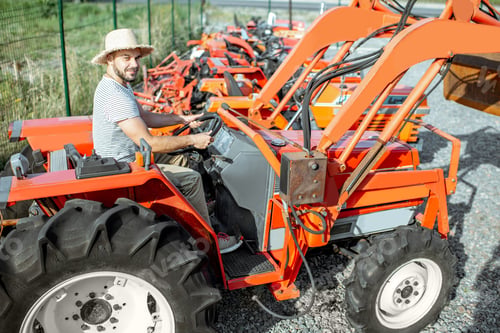Preview: Agronomist choosing tractor at the agricultural shop
