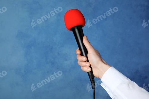 Preview: Woman holding microphone on color background, space for text