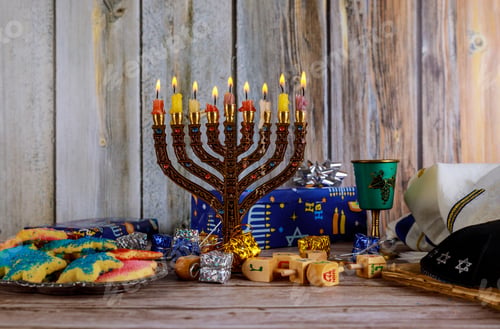 Preview: Hanukkah Candles, Jewish Holidays traditional Candelabra , donuts and wooden dreidels spinning top .