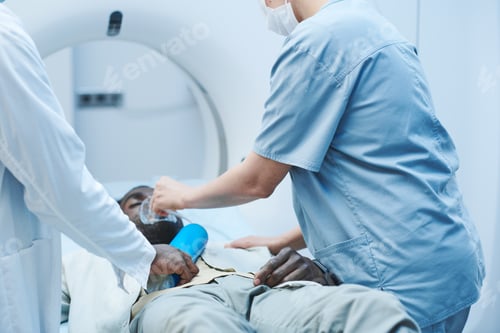 Preview: Afro-American man getting oxygen mask from doctors
