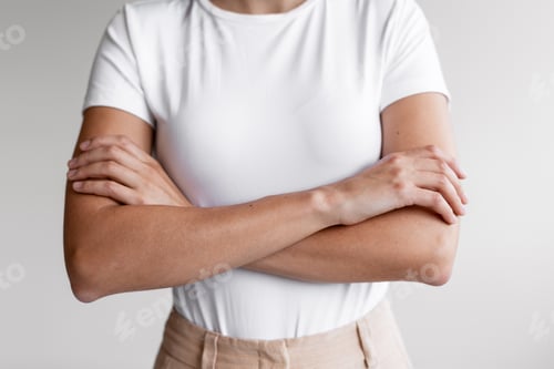 Preview: Woman showing confident body language with crossed arms closeup, selective focus