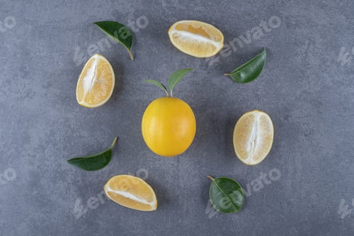 Preview: Lemon slices and leaves on grey background
