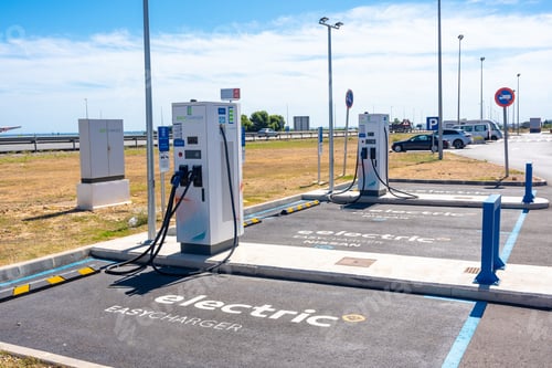 Preview: Electric car chargers at a gas station, with a parking space. ecological mobility