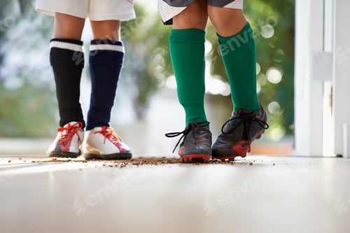 Preview: Cropped shot of two boys in sports clothing standing in a doorway