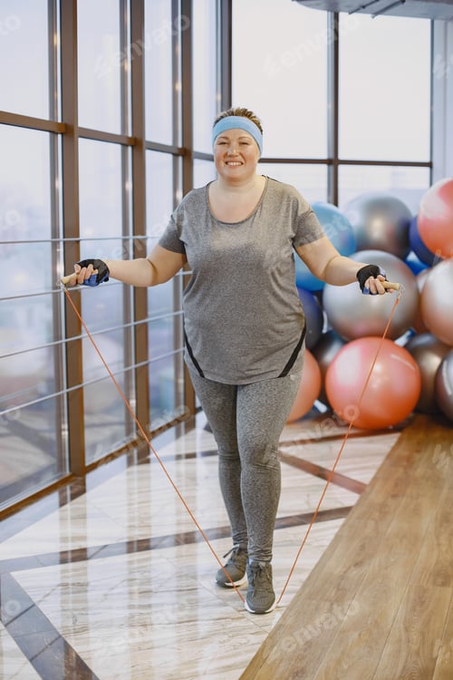 Preview: Adult fat woman doing gymnastics at the gym