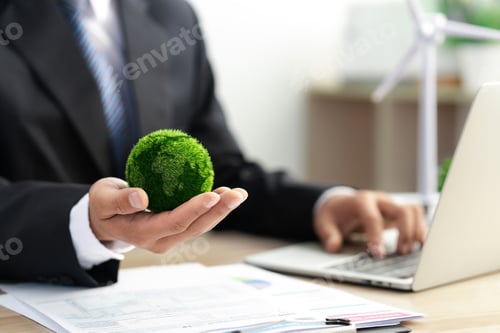 Preview: Businessman holds a green ball globe. ESG concept. Environmental, social and governance