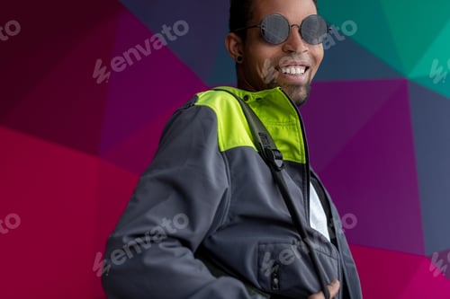 Preview: Cheerful black hipster looking at camera