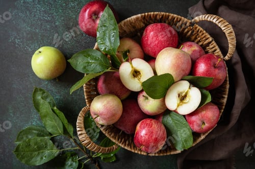 Preview: Basket of ripe apples on a stone table. View from above.